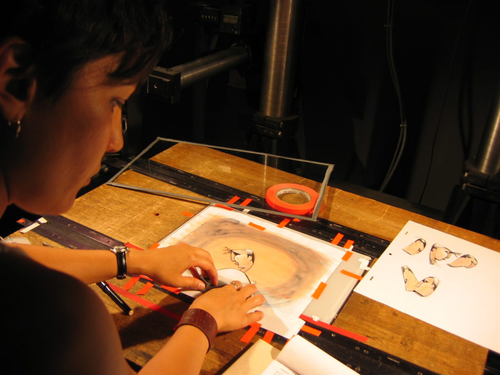 Susan putting artwork down on the animation table.
